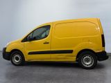 the yellow van is parked on the concrete floor in the room