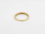 a gold wedding ring with a diamond set in the center