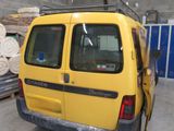 a yellow van that is parked in a garage