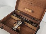a small wooden box with a telescope inside of it