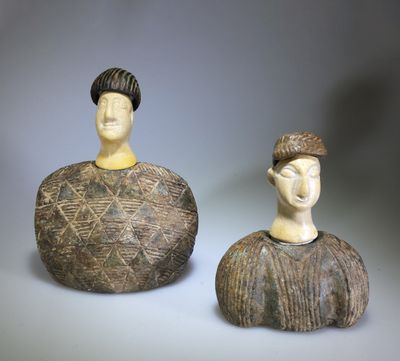 pair of ceramic figurines of a man and a woman