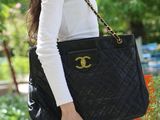 chanel black quilted lambskin tote bag, white long - sleeved top, blue jeans, black pumps, black chanel bag, black chanel
