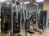 a gym room with machines and other equipment in it