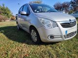 a picture of a silver car parked in the grass