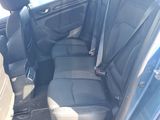 the back seats of a car are empty in a parking lot