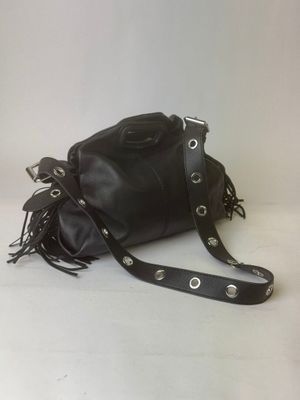 leather handbag with fringes and rivets on a white background