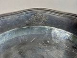 a silver tray with a handle on a table