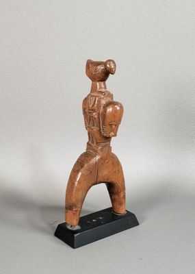 an image of a wooden statue of a man holding a ball