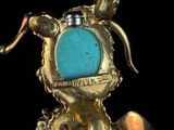 a close up of a brooch with a dog on it