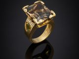 an 18k gold ring with a smoky quartz and diamonds