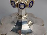 silver plated candle holder with blue and gold decorations on top