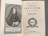 an old book with a picture of a woman in a nun ' s robes