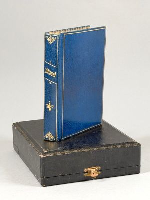 a blue book sitting on top of a black box
