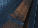 a close up of a person wearing a blue shirt and tie