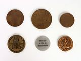 several different coins are shown on a white surface
