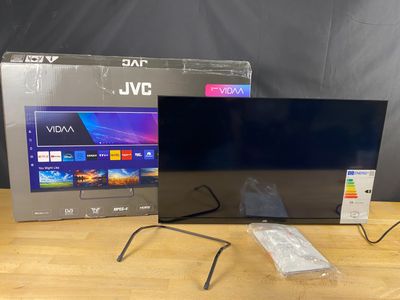 the tv is sitting on the table next to the remote control