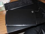 a laptop computer sitting on top of a black desk