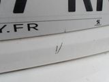 a close up of a street sign on a white surface