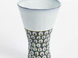 a white vase with a black and white design on it