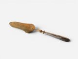 an image of a knife with a handle on a white surface