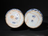 pair of blue and white vases with numbers on them on a black surface