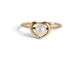 a close up of a gold ring with a pearl in the middle