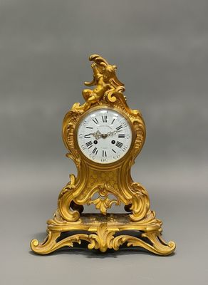 a gold clock that is sitting on a table