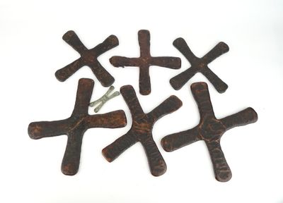 four crosses made out of wood on a white surface