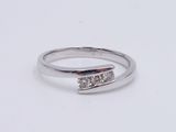 a close up of a diamond ring on a white surface