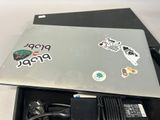 a laptop with stickers on it sitting in a box