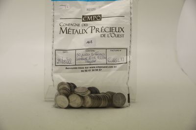 un sac de pièces posé sur une table à côté d'un autre sac de pièces