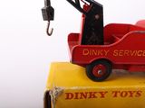 a red toy truck with a crane on top of it