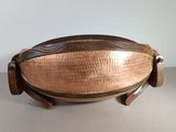 an image of a large copper platter with handles on a table