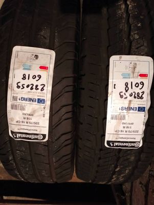 two tires on a shelf with price tags on them