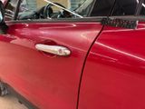 a close up of a car door handle with a sticker on it