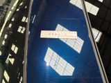 a sticker on the back of a blue suitcase