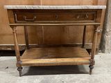 an old wooden table with marble top and two drawers