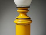 an image of a yellow table lamp with a white ball on top of it