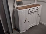 a white cabinet with a mirror on top of it
