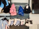 many pairs of socks hanging on a rack in a store
