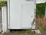 a white toilet sitting in the middle of a parking lot
