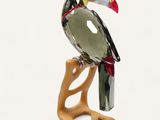 a glass toucao sitting on top of a wooden stand