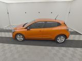 an orange car is parked in a room with a checkered floor