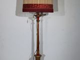 a lamp that is sitting on the floor next to a wall