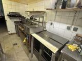 a large kitchen with a lot of stainless steel counter tops