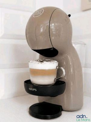 a coffee machine that has a cup of coffee in it