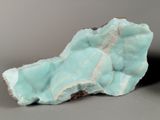two pieces of blue and white rock on a gray surface
