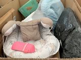 a cardboard box filled with lots of stuff and a stuffed animal