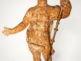 statue of a boy with a torch in his hand on a wooden base