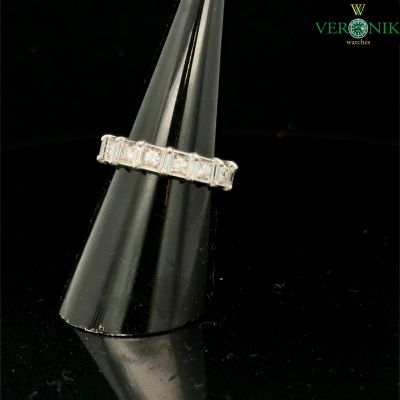 an image of a diamond ring on a black surface
